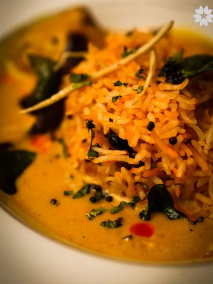 A close up of a fragrant biryani, with each grain of rice distinct and flavourful. We take pride in perfecting traditional Indian dishes, presenting them with the respect and care they deserve.