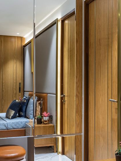 The dressing area within a bedroom at the Filigree House. The mirrored wardrobe doors reflect the space, making it feel larger, while the warm wood tones maintain a cozy atmosphere.