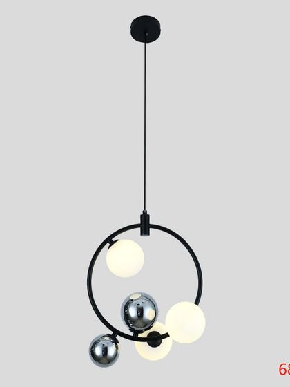 A minimalist pendant with a black ring holding frosted and chrome globes. This design is perfect for a contemporary kitchen or hallway.