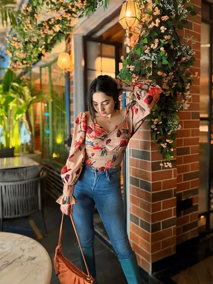 A stylish pose at Sunday House, a West Delhi cafe with beautiful floral decor and brick walls.