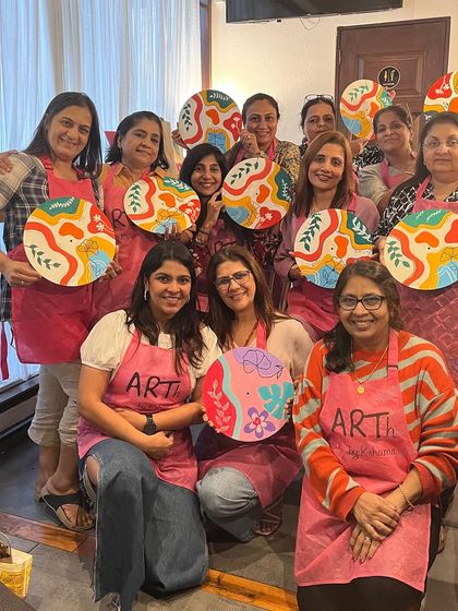 A group of ladies enjoying a creative kitty party, painting colorful boho clocks. An art workshop is a unique and engaging alternative to a typical get together.