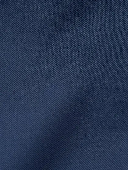 The smooth surface of a navy wool twill, a fabric known for its durability and classic appeal.