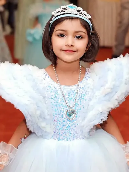 The birthday girl dressed as her favorite character, Princess Elsa. We help create these picture-perfect moments by ensuring the party's theme extends to every detail, making the child feel truly special.