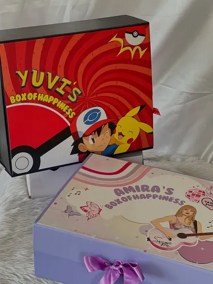 Two different themes for two different personalities. On the left, a popstar-themed 'Box of Happiness' for Amira, and on the right, the Pokémon-themed box for Yuvi.