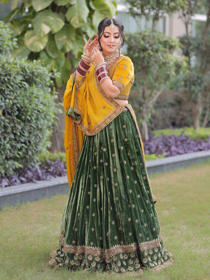 A candid moment of bridal beauty. The soft glam makeup with a pop of red on the rose in her hair adds a touch of romance to this traditional look.