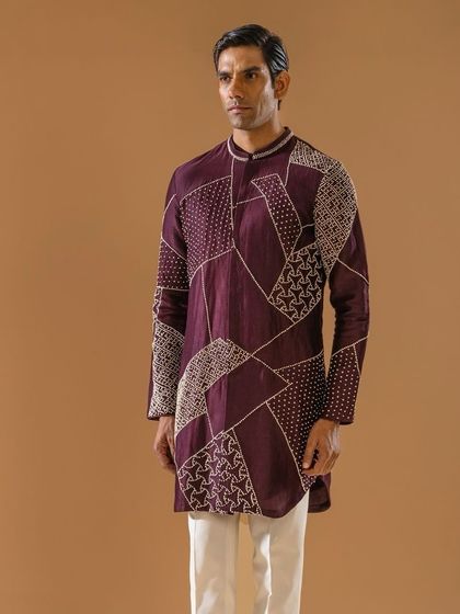 A full-length view of the deep plum kurta with geometric embroidery. This outfit is perfect for amplifying even the smallest occasions with a hue of panache.