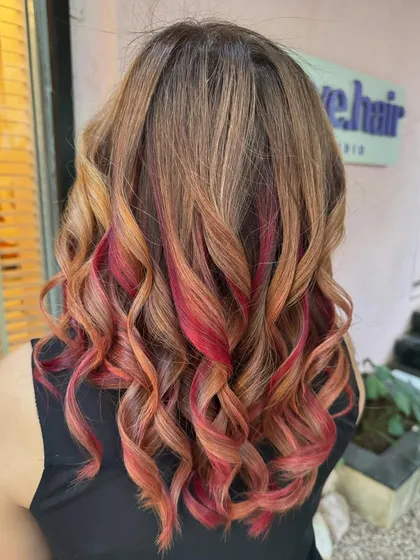 A side view of the flaming red and copper hair. The colors are beautifully blended for a multi-tonal look.