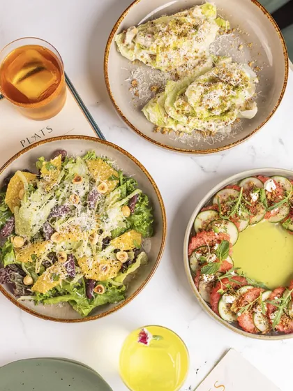 A beautiful overhead shot of our three signature salads, showcasing their vibrant colors and fresh ingredients.