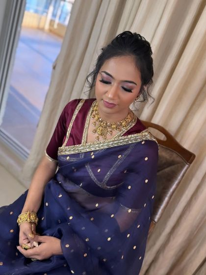 A close-up of the makeup that goes with this hairstyle, featuring soft, smoky purple eyes.