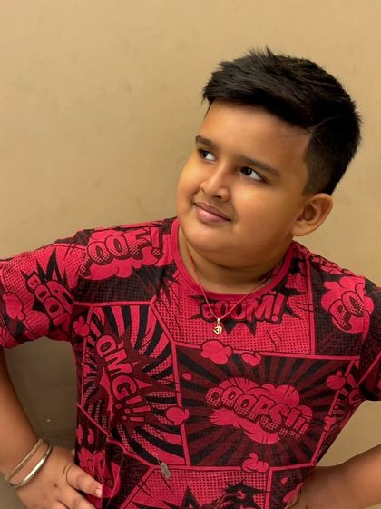 This young client is looking sharp and stylish with his new haircut, ready to take on the world with confidence.