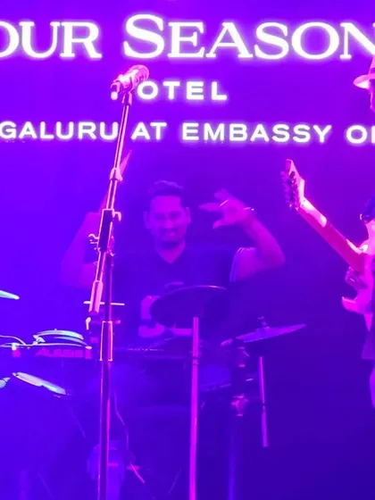 Our drummer and guitarist interacting on stage during the performance at the Four Seasons.
