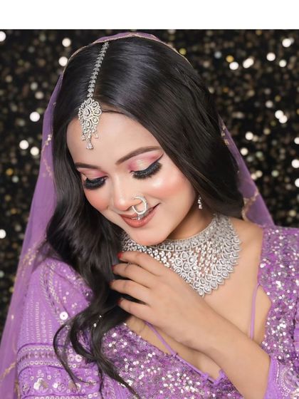 A model in a purple sequin lehenga wearing a beautiful diamond choker. This is a great look for a cocktail party or a glamorous photoshoot.