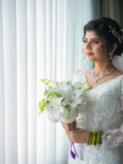 A lovely, natural-looking bridal portrait. The bride looks serene and beautiful as she gazes out the window on her wedding day.