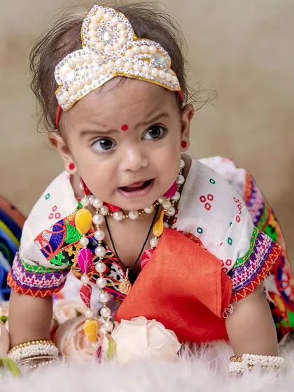 Another adorable crawling shot, this time of a baby Radha in a traditional bandhani-style outfit.