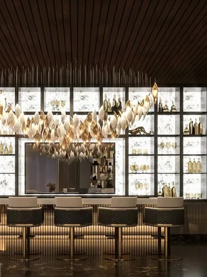 A dynamic and luxurious bar I crafted for a project at DLF Camellias. The backlit shelving, statement chandelier, and dark marble create a sophisticated atmosphere perfect for entertaining.