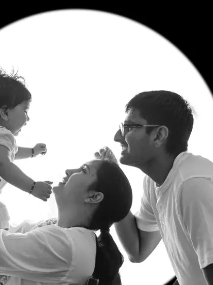 A black and white version of the circular backlit family portrait. Monochrome enhances the graphic quality and emotional impact of the image.