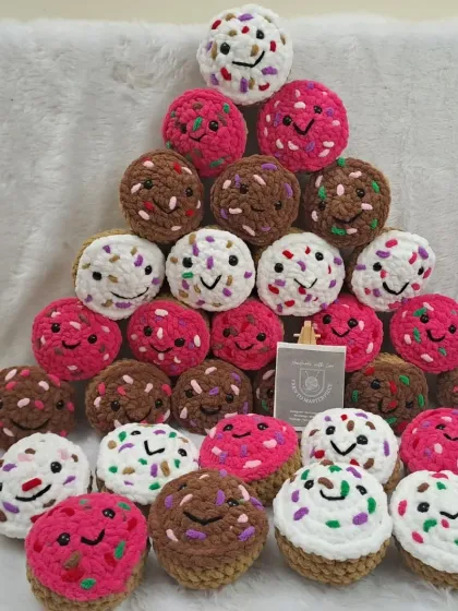 A large collection of the cupcake plushies, ready for a birthday party. They are a sweet and sugar-free treat for guests.