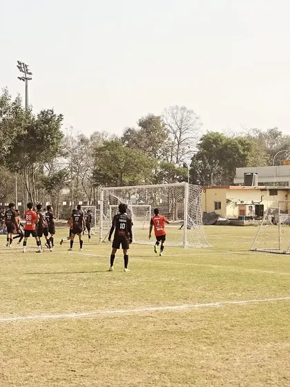 A view of our team organizing for a set-piece situation near the opponent's goal during a Super League fixture.