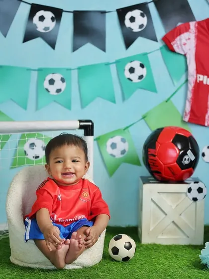 A happy little football fan celebrating his half-birthday. Themed shoots like this are a great way to incorporate your family's passions into your child's photos.