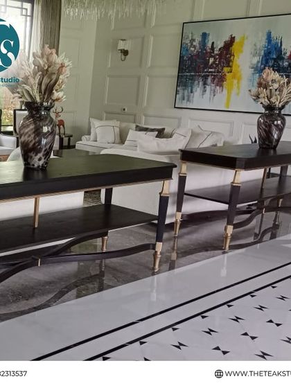 A look at a sophisticated living room we furnished. This space features our custom console tables with elegant metal-tipped legs, showcasing how we can create pieces that harmonize with a luxurious interior.