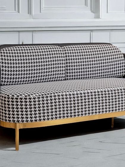 The Scottish Plaid accent two-seater sofa is a bold statement piece. The classic black and white houndstooth pattern is paired with a sleek stainless steel frame, creating a perfect blend of classic and contemporary design.