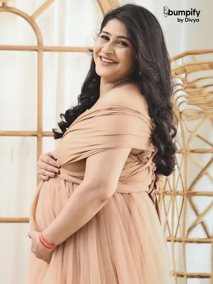 A close-up shot capturing the joyful smile of the mom-to-be. Her happiness is infectious in this beautiful, naturally lit portrait.