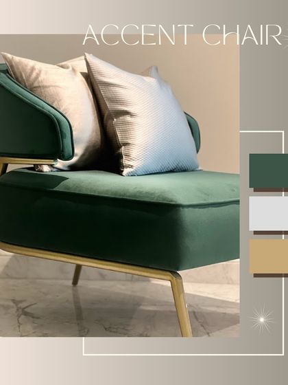 An accent chair that adds a touch of elegance and comfort. This piece features rich green fabric, a sleek gold metal frame, and grey-hued cushions for a stunning look.