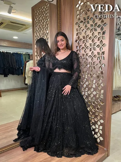 Make a bold statement at your next cocktail or reception party with this stunning all-black sequined lehenga. This full-length view shows the incredible sparkle and flow of the skirt, a perfect pre-loved designer find.