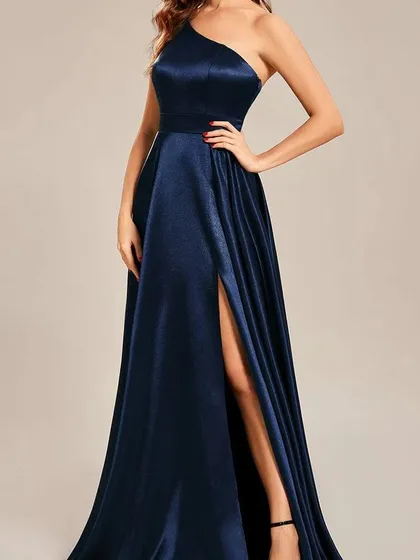 A full-length view of my one-shoulder satin gown in a deep navy blue. The design is both classic and modern, with a fitted bodice and a flowing skirt with a slit.