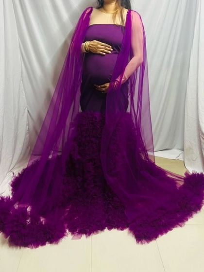 The sheer cape on this purple maternity gown adds a layer of elegance and provides different styling options for your photoshoot.