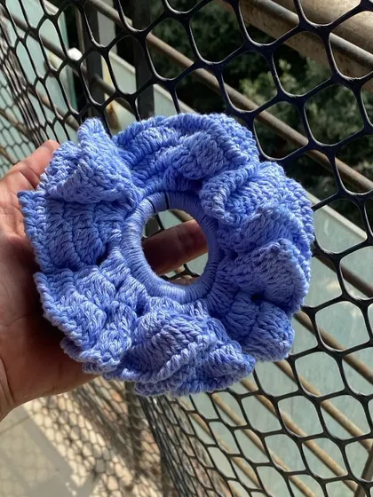 This is my XL cloud scrunchie, made with soft cotton yarn. It's designed to be gentle on your hair while adding a fun, voluminous touch to your ponytail or bun.