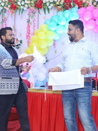 Explaining the "secret" to a very confused but amused audience volunteer. My comedy magic is all about these fun, light-hearted interactions that get everyone laughing.