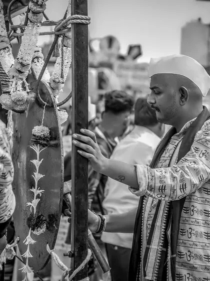 A black and white shot of a musician with the 'todi', a traditional instrument.