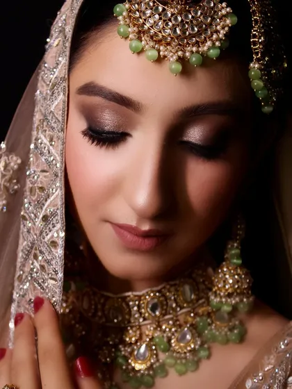 A close-up portrait of this modern bridal fusion look. The soft smokey eye and nude lip create a sophisticated and elegant feel.