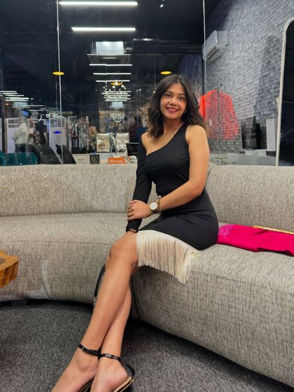 A little black dress with a twist. The fringe detail on this one-shoulder piece adds a playful and stylish element, perfect for a party.