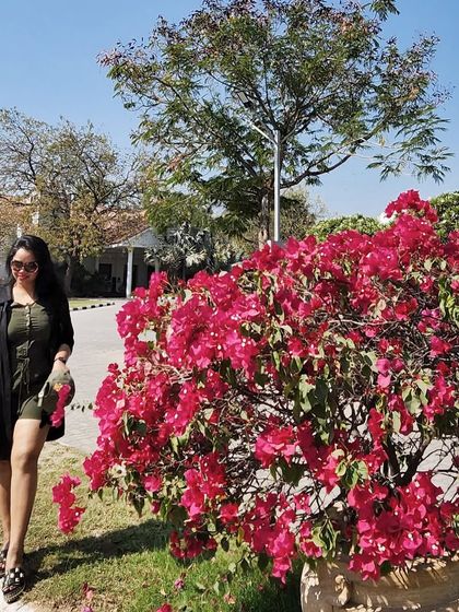 Enjoying the sun by the bougainvillea. This casual travel look is perfect for a relaxed day at a resort.