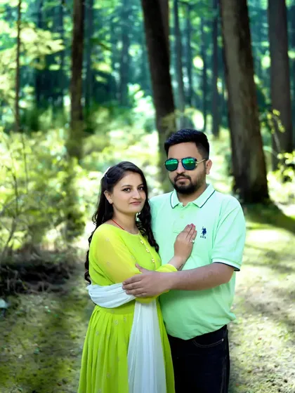 A stylish couple's pose in the forest, with both partners looking confidently at the camera. This showcases a more modern and fashion-inspired approach to pre-wedding photography.