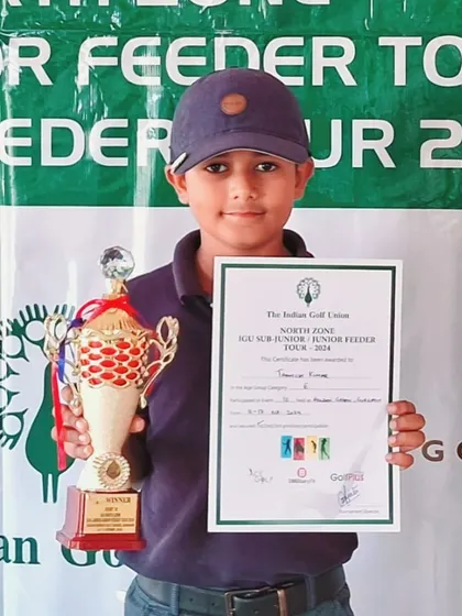 Taanush Kumar proudly holds his trophy after winning in the E Category at the IGU Feeder Tour.