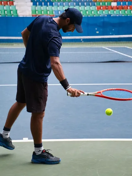 Getting a feel for the ball and the racquet is part of the pre-session ritual. It's these small moments of focus that prepare you for the hard work ahead.