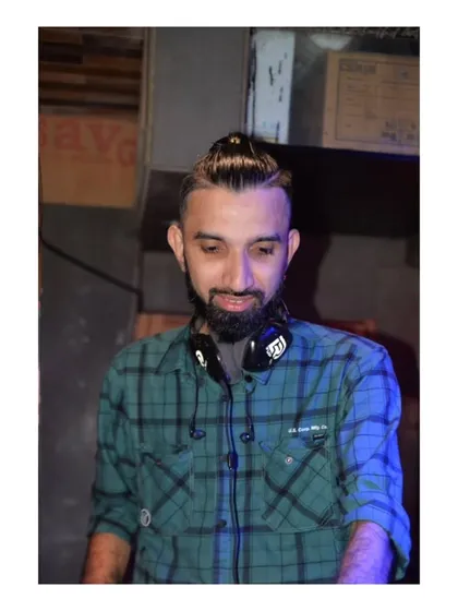 A candid photo of me between mixes, with my headphones around my neck.