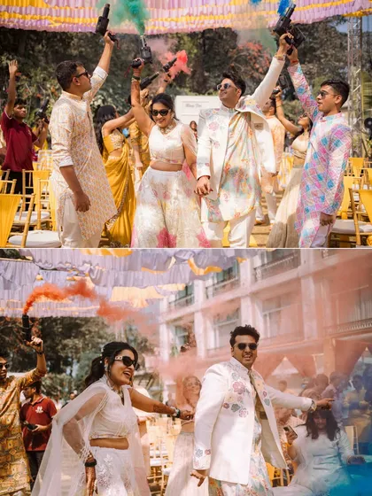 A grand entrance with a bang! The couple enters their Haldi celebration with colorful smoke bombs, creating a vibrant and exciting photographic moment.