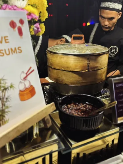 A view of our "Live Dimsums" station, complete with illustrated signage and traditional steamers. This station is a unique and flavorful option that adds an authentic touch to any event.