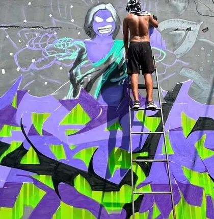 Another shot of me working on the "Attitude Adjustment" piece. You can see the layers of purple and green coming together. Repping India with my partner in crime.
