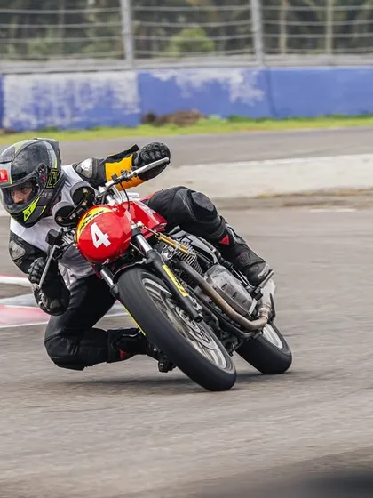 A rider leans into a corner during the RE GT Cup qualifiers. Our training helps amateur riders find their footing on the track and compete at a high level.