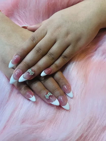 A close-up of our classic French manicure, enhanced with a sparkling 3D rhinestone bow.