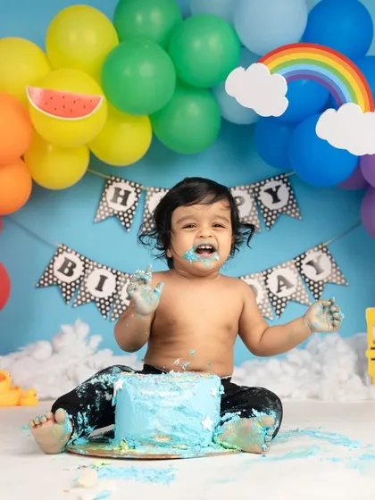 A first birthday is all about joy, and what's more joyful than a cake smash? This little one had the best time making a mess, and his happy, frosting-covered face says it all.