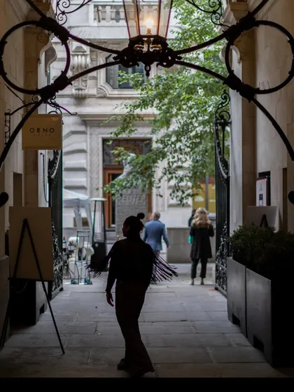 A silhouette captured while walking through an old arcade. I'm always drawn to the stories of old structures, the way they frame the light and the life passing through them.