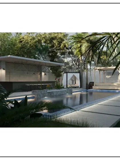 A dream outdoor entertainment area. This design features a swimming pool with an adjacent covered bar and a private cabana, all surrounded by tropical landscaping to create a private resort-like feel.