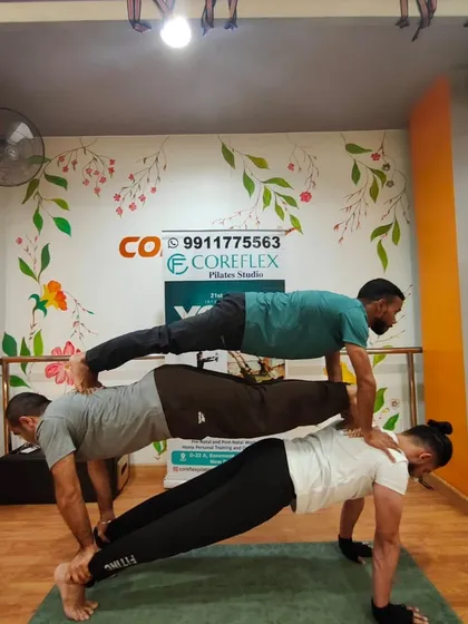 A human plank tower built on trust and teamwork. Our yoga sessions often include playful and challenging partner poses that build both strength and bonds.