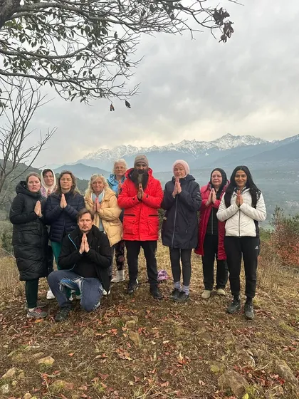 A group of students from Europe joining me for a workshop in the Himalayas. We stand together in Namaste, honoring the divine light within each of us, with the majestic mountains as our witness.